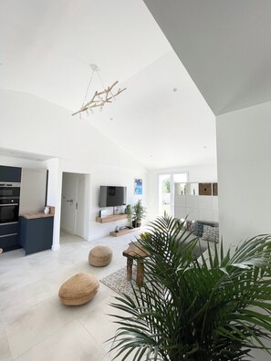 A modern interior with a kitchen, dining area, and living space.
