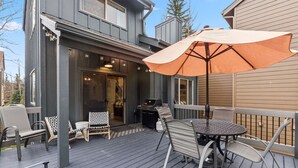 A deck with outdoor furniture, a grill, and a large umbrella. - Renovated Frisco Retreat Near Main St & 4 Ski Resorts (Frisco)
