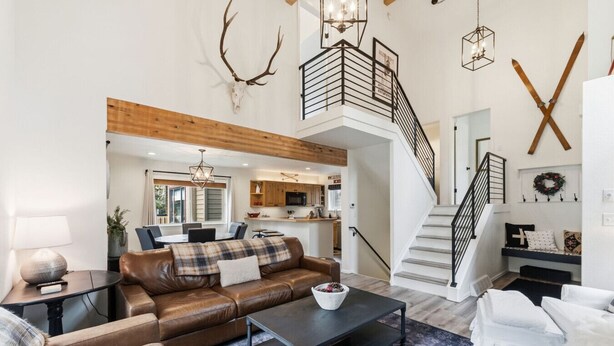 A spacious living area with a leather sofa, a coffee table, and a staircase leading to an upper level. - Renovated Frisco Retreat Near Main St & 4 Ski Resorts (Frisco)