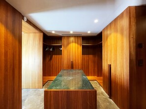 A conference room with a long table, wooden paneling, and recessed ceiling lighting. - Carthage Villa | 3BR Luxury · Pool · Garden (Carthage)
