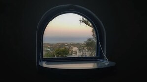 A window with a view of a landscape, including buildings and trees. - Simplicity Suite, Sea view, cosy place near Fira Center, high speed internet! (Fira)