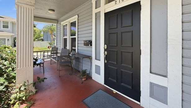 A house with a porch, a black door, and a mailbox. - Tampa Heights 2BR Near Riverwalk (Tampa)