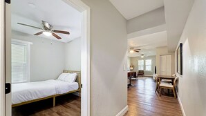 A bedroom with a bed, a ceiling fan, and a window with blinds. - Tampa Heights 2BR Near Riverwalk (Tampa)
