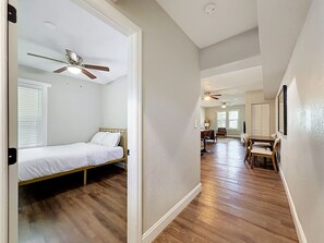A bedroom with a bed, a ceiling fan, and a window with blinds. - Tampa Heights 2BR Near Riverwalk (Tampa)
