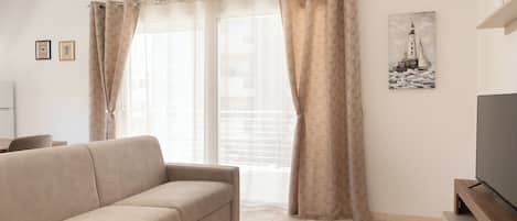 Comfort Apartment, 1 Bedroom, Balcony | Living area | 30-inch TV with satellite channels