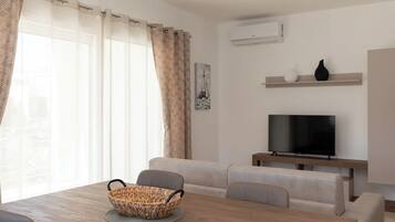 Appartamento Comfort, 1 camera da letto, balcone | Area soggiorno | TV 30 pollici con canali satellitari