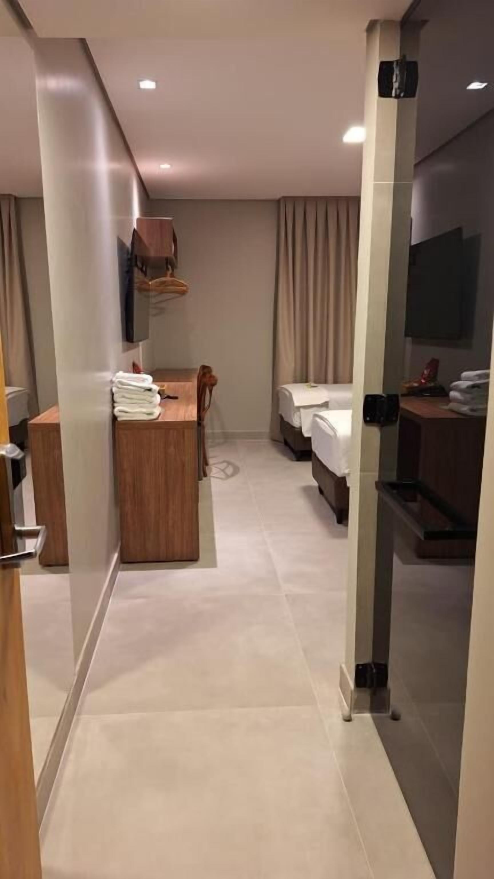 Deluxe Triple Room, City View | Desk, laptop workspace, soundproofing, iron/ironing board