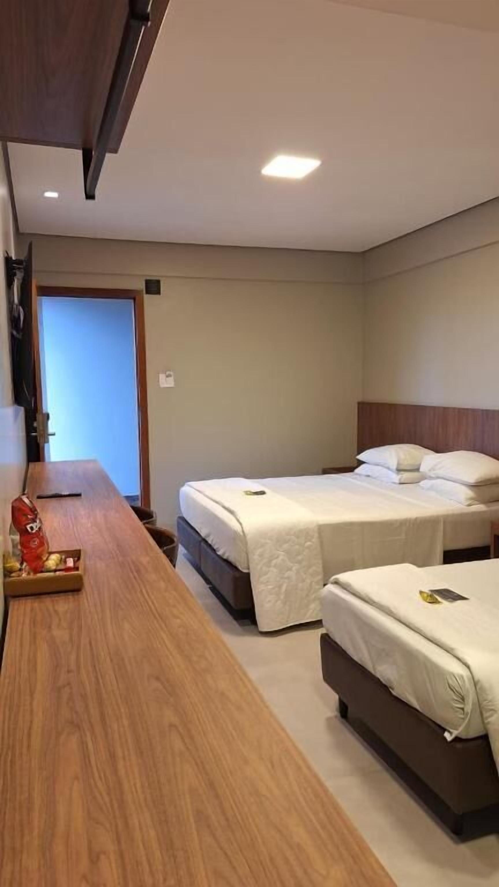 Deluxe Triple Room, City View | Desk, laptop workspace, soundproofing, iron/ironing board