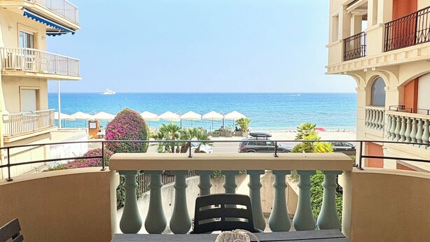 A balcony with a table, chairs, and a view of the sea. - Seafront Terrace & Wi-Fi [600m from station]. (Menton)