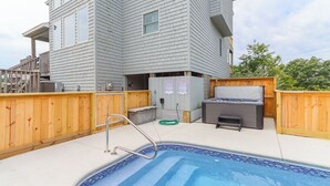 A swimming pool with a wooden deck, a hot tub, and a barbecue grill. - Sun Realty pet-friendly oceanside Duck home w/ pool, hot tub & sound views (Duck)