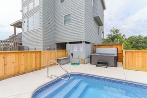 A swimming pool with a wooden deck, a hot tub, and a barbecue grill. - Sun Realty pet-friendly oceanside Duck home w/ pool, hot tub & sound views (Duck)
