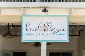 A sign for 'beach blossom studio' with a coastal design element. - Casa Del Sol | Rooftop Deck, Pool + Ocean Views (Anna Maria)
