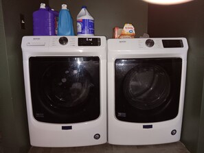 Two front-loading washing machines with a control panel and a 10-year warranty label.