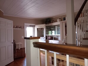A staircase with a wooden handrail leading to a landing.