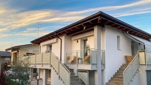 A two-story house with a balcony, a staircase, and a clear sky. - Villa Luigia Garda. "Azure" (Peschiera del Garda)