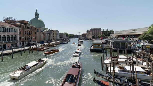 A canal with boats, buildings, and a dome structure. - Daisy Flowers by Wonderful Italy (Venice)