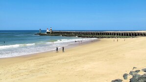 A beach with a pier and a lighthouse. - Les mimosas by Interhome (Capbreton)
