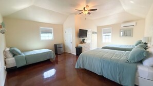 A bedroom with two beds, a ceiling fan, a TV, and a dresser. - Tiny home in lovely Rockport TX-Frigate House #2 (Rockport)