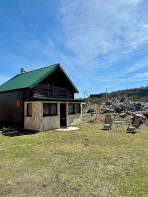 A rustic cabin with a stone facade, a green roof, and a small porch area. - Cabin Varde | 2-bedroom cabin in charming Žabljak (Žabljak)