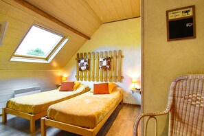 A room with two wooden beds, a skylight, a wall-mounted wooden rack, and a wicker chair. - Guest Room “Chambre La Laitière” with Terrace, Shared Garden and Wi-Fi (Teurthéville-Bocage)