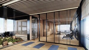 An indoor space with a wooden floor, exercise equipment, and a glass partition. - Cozy Riverside Apartment- Lumiere Skyway (Ho Chi Minh City)