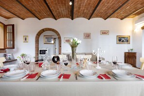 A dining table set for a meal with plates, glasses, and cutlery. - Villa Cielo Toscano in San Miniato with Exclusive Pool (San Miniato)
