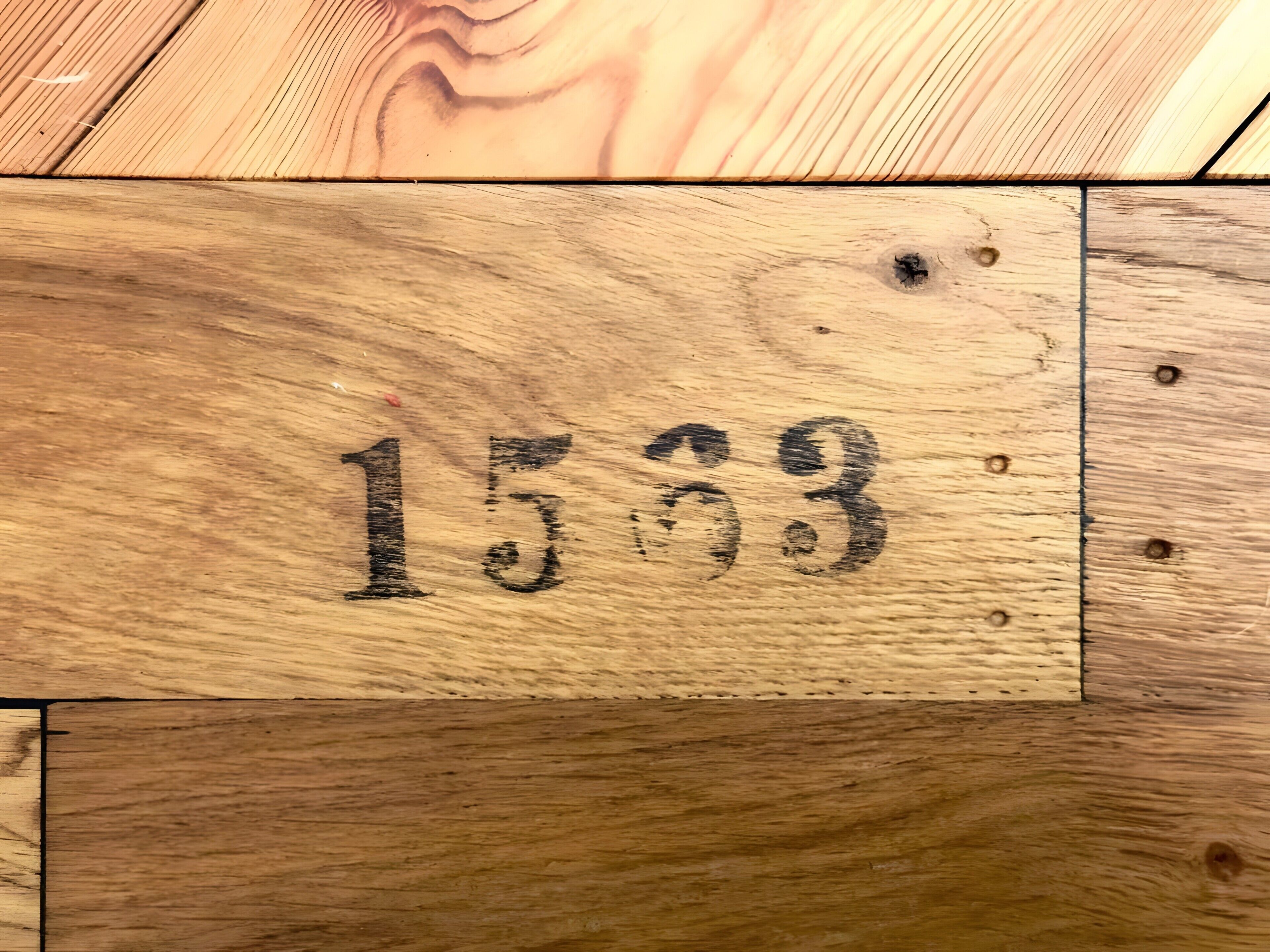 A wooden floor with a number '1533' etched into it.