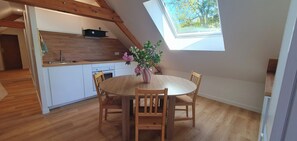 Eine Küche mit Holzausstattung, einem Spülbecken und einem Fenster über der Arbeitsfläche.