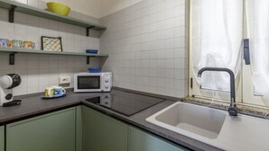 A kitchen with a microwave, kettle, and a sink. - This colorful and welcoming apartment, ideal for up to 4 people, is strategically located in Lecce: outside the restricted traffic zone but just steps from the historic center. Just 400 meters from Porta San Biagio, it's easy to immerse yourself in the w (Otranto)