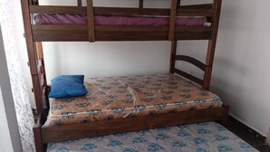 A bunk bed with a mattress labeled 'FLEX' and a blue pillow.