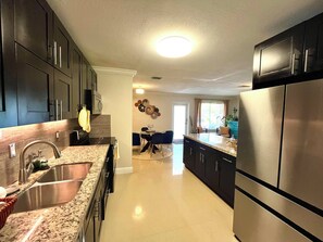 Fridge, microwave, oven, stovetop - Charming 3-bedroom bungalow in Sunrise with AC and patio family & pet friendly (SUNRISE)