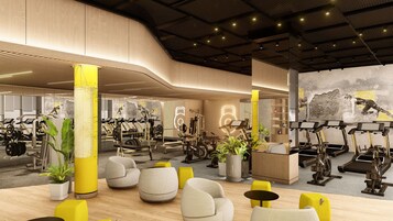 A modern gym with exercise equipment, seating areas, and a mural.