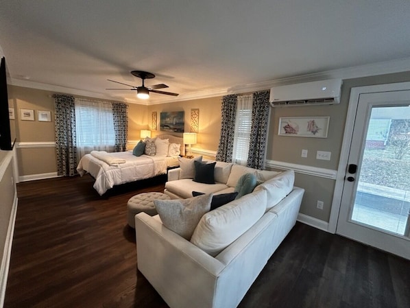 A room with a bed, a sofa, a ceiling fan, and a door with a view. - Beautiful 3 bed/2 bath with Private Suite (Lillington)