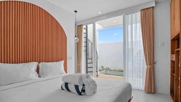 A modern hotel room with a bed, a view of the sky, a balcony, and a pool. - New Rooftop Jacuzzi & Private Pool Villa near Canggu/Seminyak. (Bali)