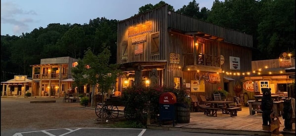 A rustic building with a sign for breakfast, a mailbox, and a Coca-Cola sign.