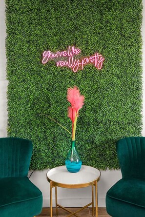 A room with a green wall, a round table with a gold frame, and two green chairs. - Best Location! Walk to Midtown Bars (Nashville)