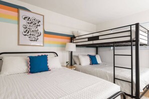 A room with bunk beds, a bedside table with a lamp, and a framed quote on the wall. - The Lyric -Live Like a Local on Music Row (Nashville)