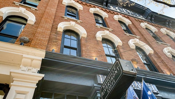 A brick building with a sign reading "Nashville Riverfront Lofts." - Historic Riverfront Condo for 8, Near Broadway! (Nashville)