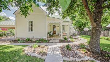A single-story house with a front porch, a mailbox, and a number '705' on the door.