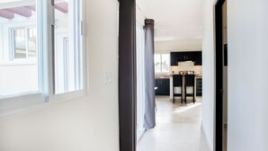 A modern kitchen with dark cabinets, a countertop, and a window. - Casa Rama 2. 2 bedroom, 2 bathroom w/ private pool in Cozumel (Cozumel)