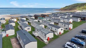 Filas de casas móviles con vista a la playa y al océano.