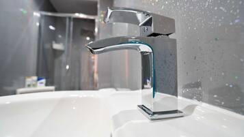 Shower, hair dryer, towels, shampoo