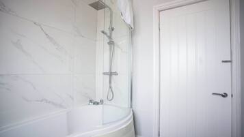 Shower, hair dryer, towels, shampoo