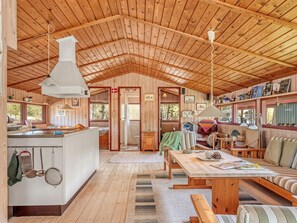 Ein Ferienhaus-Innenraum mit Küche, Essbereich und Schlafbereich.
