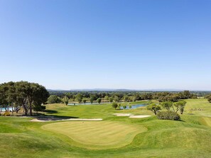 A golf course with a clear view of the landscape, including trees, water bodies, and distant hills. - Provence Country Club by Interhome (L'isle sur la Sorgue)