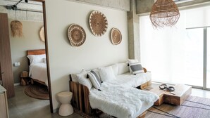Ein modernes Zimmer mit einer Couch, einem Holztisch und einer Pendelleuchte.