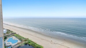 A beach view with a pool and lounge area. - Myrtle Beach Resort Renaissance Tower #2001 (Myrtle Beach)