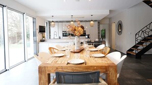 A modern kitchen with a dining area. - Villa du Château - vue imprenable sur le château médiéval (Talmont-Saint-Hilaire)