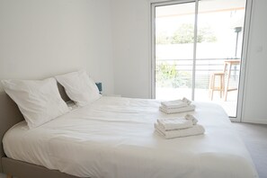 A bedroom with a bed, pillows, and folded towels. - Clos des Sables B13 - Two Bedroom Apartment, Sleeps 4 (Les Herbiers)