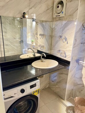 A bathroom with a double sink, a mirror, a washing machine, and a shower area. - Tiba Golden resort chalet with pool view steps from sea (Hurghada)